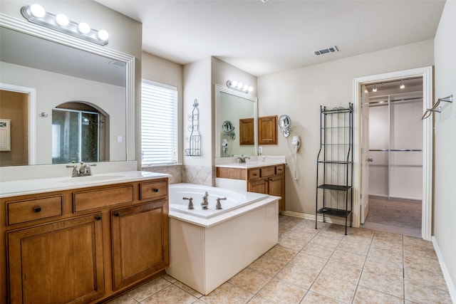 1730 Azalea Dr, Savannah, TX 76227 - full bathroom featuring a shower stall, two vanities, a garden tub, and tile patterned flooring