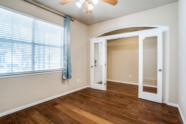 spare room featuring french doors, wood finished floors, and baseboards