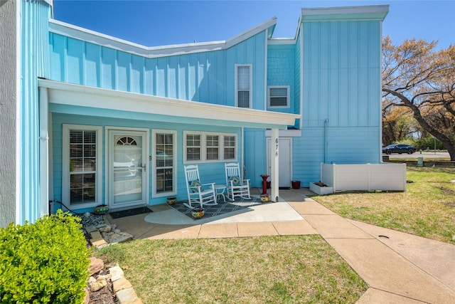 676 Harbor Dr, Azle, TX 76020 - rear view of house featuring board and batten siding, a yard, and a patio area