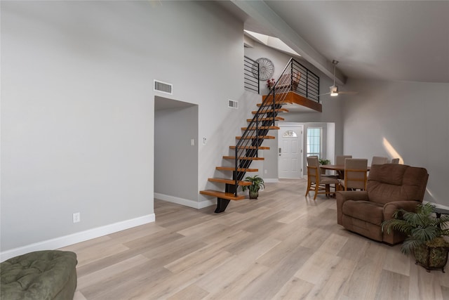 676 Harbor Dr, Azle, TX 76020 - living area with stairway, baseboards, light wood-type flooring, high vaulted ceiling, and a ceiling fan