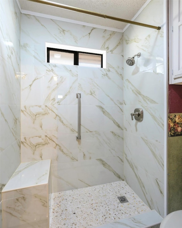 bathroom featuring a marble finish shower