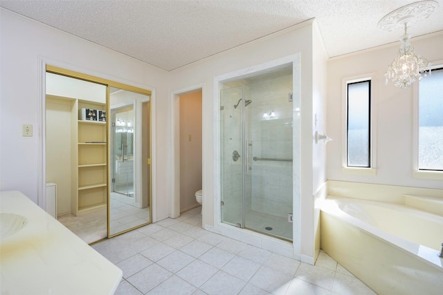 bathroom featuring a garden tub, a shower stall, toilet, and a textured ceiling