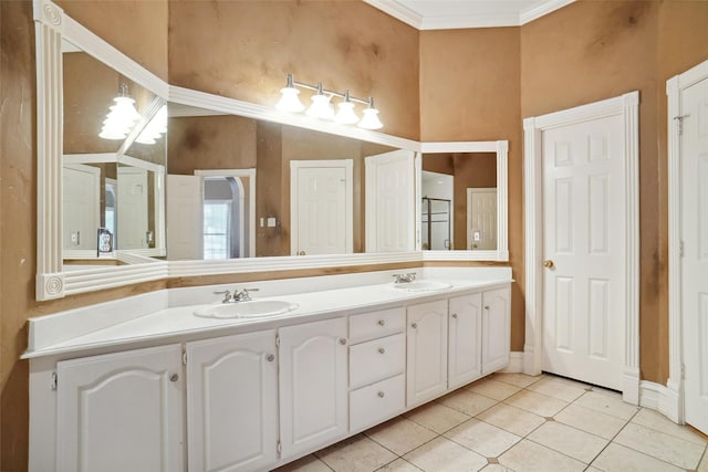 full bath featuring double vanity, tile patterned flooring, crown molding, and a sink