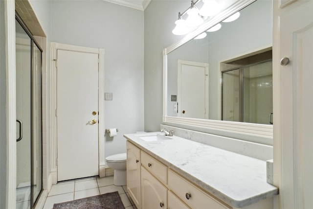 bathroom with crown molding, toilet, a stall shower, vanity, and tile patterned floors