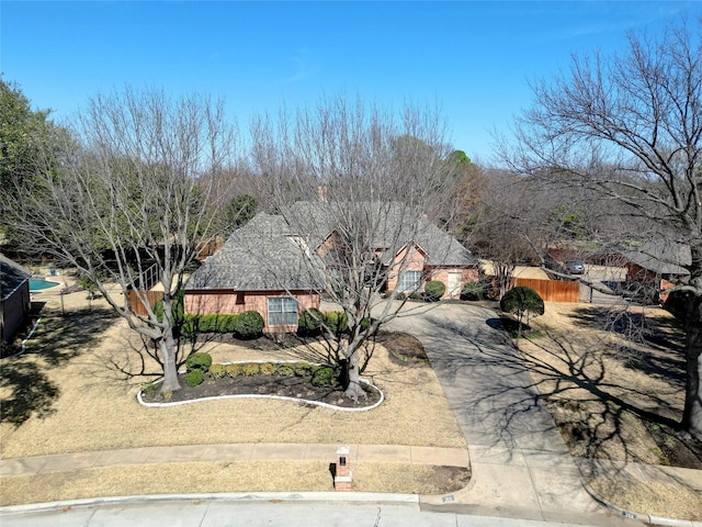 view of front of home featuring driveway and fence