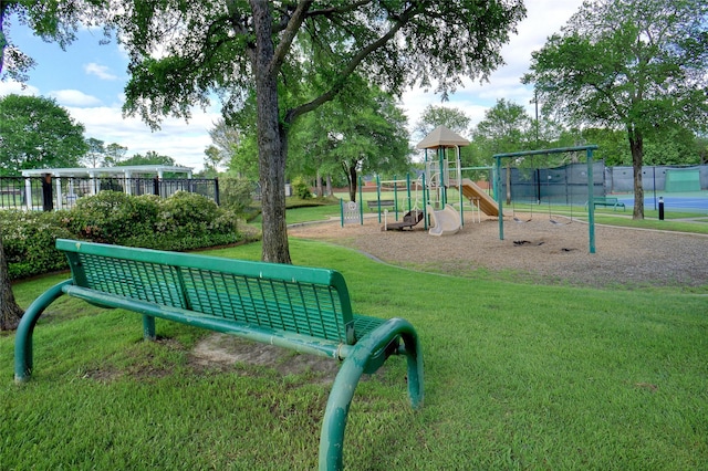 community playground with a lawn and fence