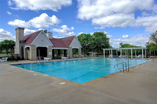 community pool with a patio, fence, and a pergola