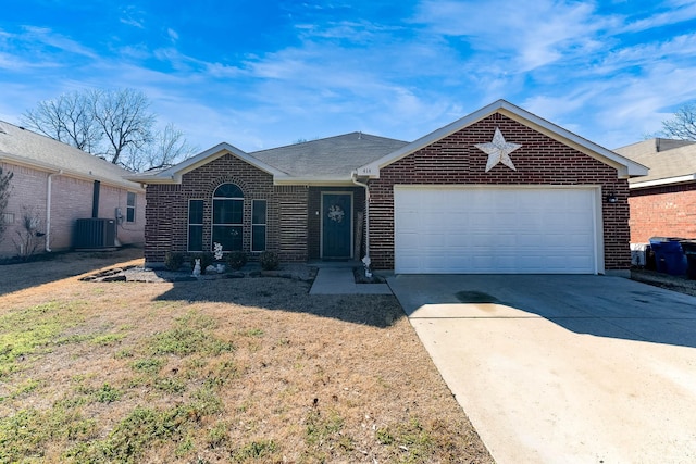 ranch-style home with a garage, driveway, brick siding, and central AC