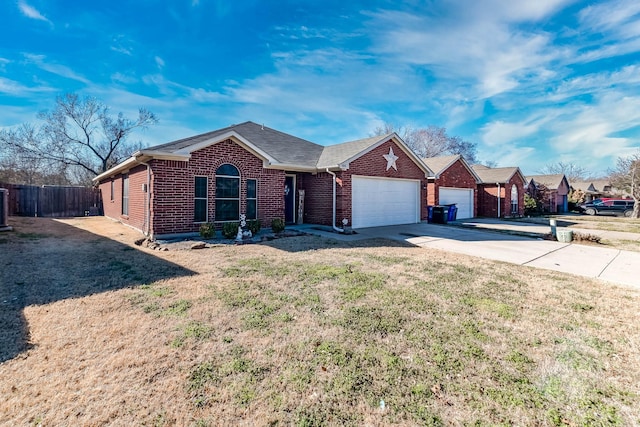 ranch-style home with an attached garage, brick siding, fence, concrete driveway, and a front yard