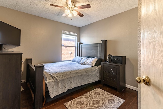 bedroom featuring dark wood-style floors, ceiling fan, baseboards, and a textured ceiling