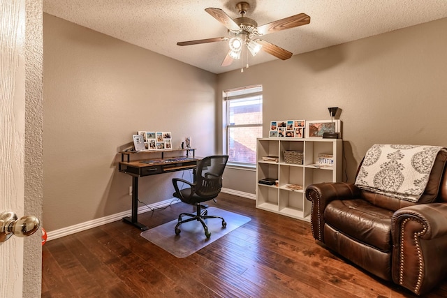 office space featuring a ceiling fan, wood-type flooring, baseboards, and a textured ceiling