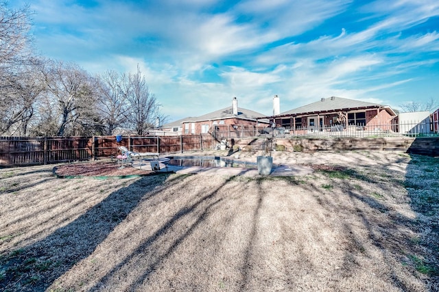 back of property featuring a fenced backyard and a patio