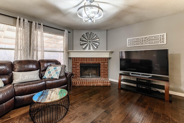 living area featuring a fireplace, a textured ceiling, baseboards, and hardwood / wood-style flooring