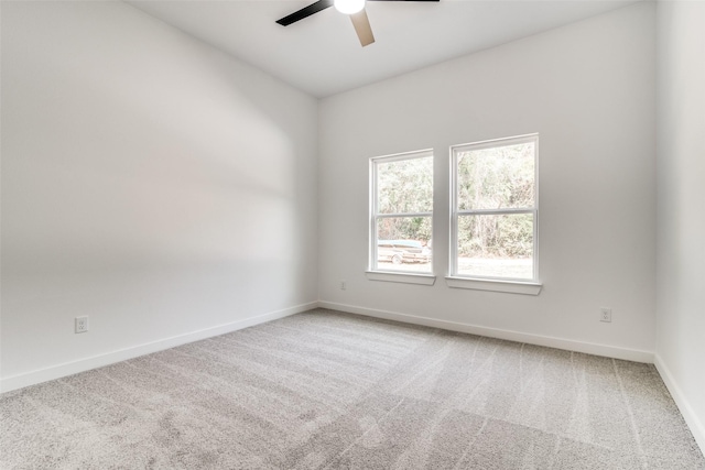 empty room with carpet, ceiling fan, and baseboards