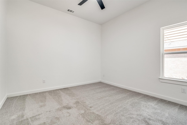 unfurnished room with ceiling fan, carpet flooring, visible vents, and baseboards