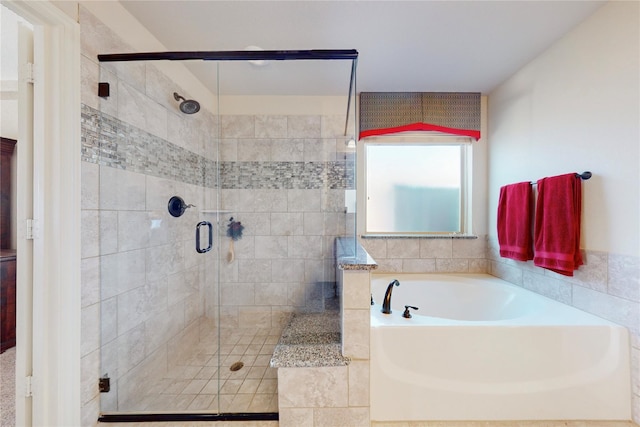 bathroom with a garden tub and a shower stall