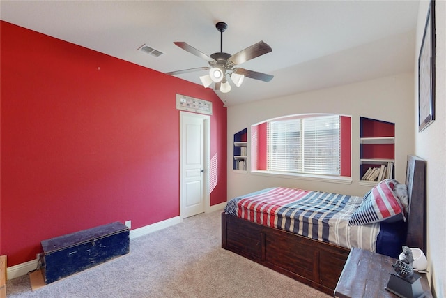 bedroom featuring lofted ceiling, carpet, visible vents, and baseboards