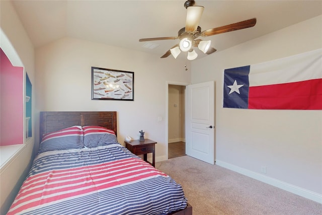 bedroom featuring carpet floors, vaulted ceiling, baseboards, and ceiling fan