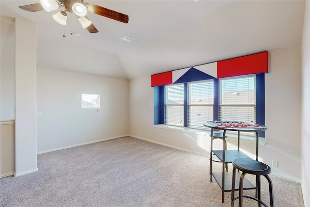 unfurnished room with baseboards, visible vents, lofted ceiling, ceiling fan, and carpet floors