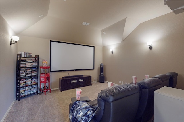 carpeted home theater room with vaulted ceiling, visible vents, and baseboards