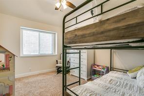 carpeted bedroom with vaulted ceiling and baseboards