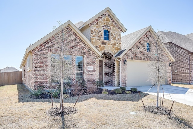 view of front of house with stone siding, concrete driveway, and brick siding