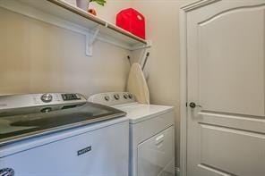 clothes washing area with laundry area and separate washer and dryer