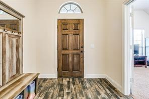 entrance foyer with wood finished floors and baseboards