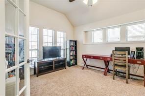 home office with lofted ceiling, ceiling fan, carpet floors, and french doors