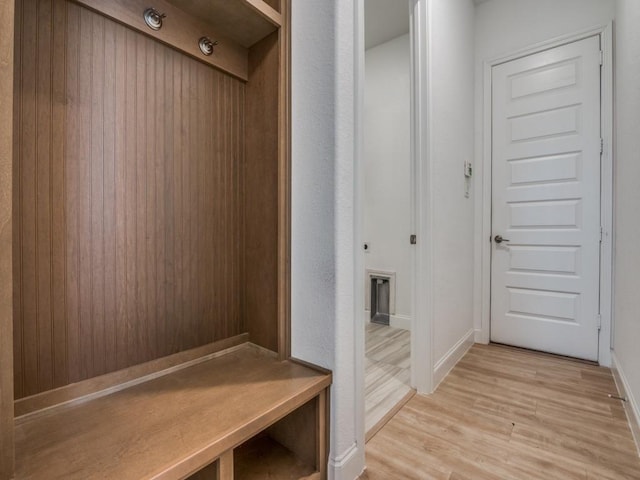 mudroom featuring light wood-style flooring and baseboards