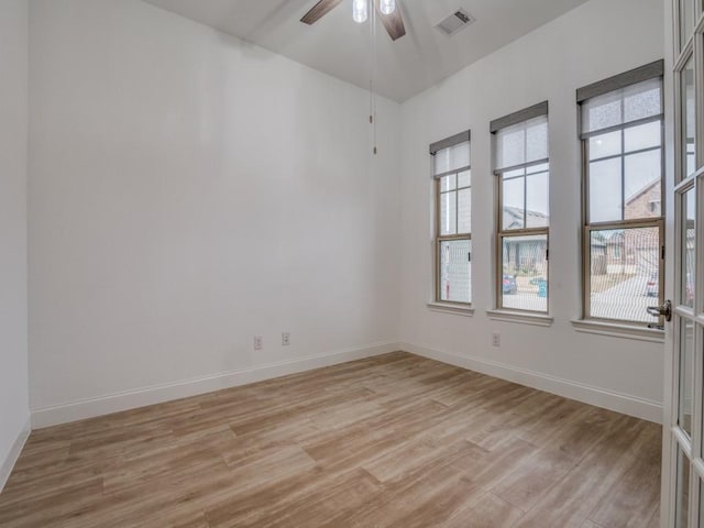 spare room with light wood-type flooring, baseboards, and visible vents