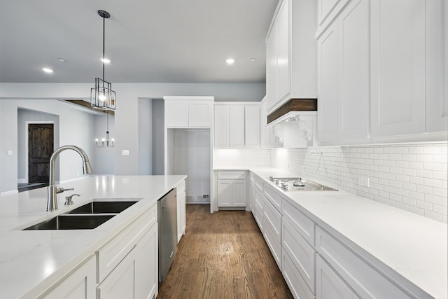 kitchen featuring dark wood-style floors, a sink, appliances with stainless steel finishes, and white cabinetry