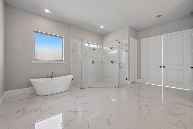 bathroom featuring a freestanding tub, a marble finish shower, marble finish floor, visible vents, and baseboards