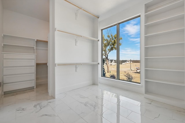 spacious closet with marble finish floor