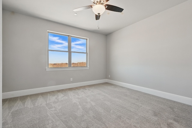 empty room featuring baseboards, ceiling fan, and carpet flooring