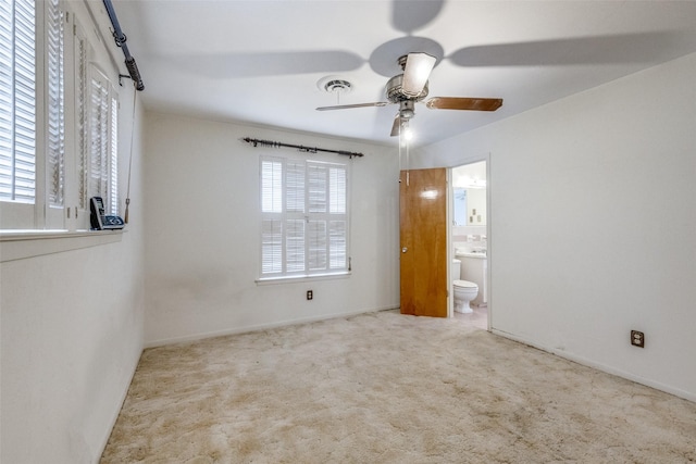 unfurnished bedroom with a ceiling fan, carpet flooring, visible vents, and ensuite bath