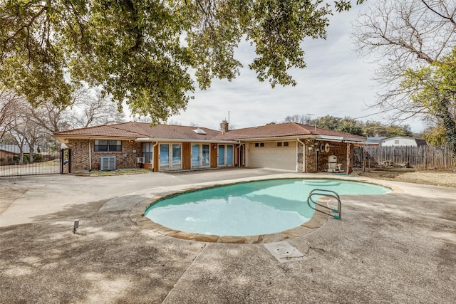 view of swimming pool featuring a patio area, fence, and a fenced in pool