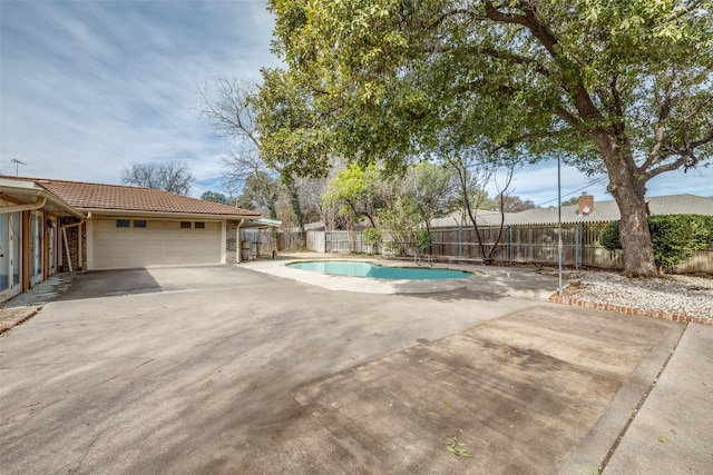 view of swimming pool featuring a patio area, fence private yard, and a fenced in pool