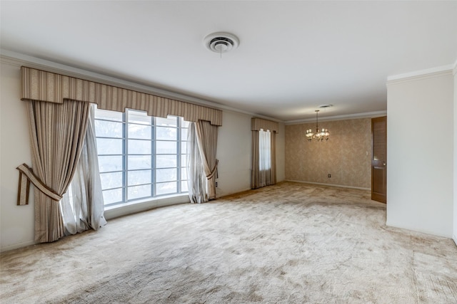 carpeted spare room featuring a notable chandelier, visible vents, baseboards, ornamental molding, and wallpapered walls