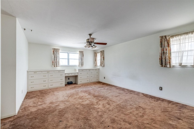 unfurnished bedroom featuring ceiling fan and light colored carpet