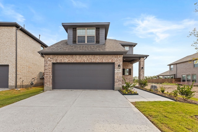 view of front facade with a shingled roof, brick siding, driveway, and fence