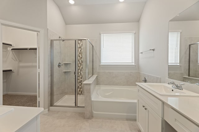 full bathroom featuring a stall shower, vanity, and a spacious closet