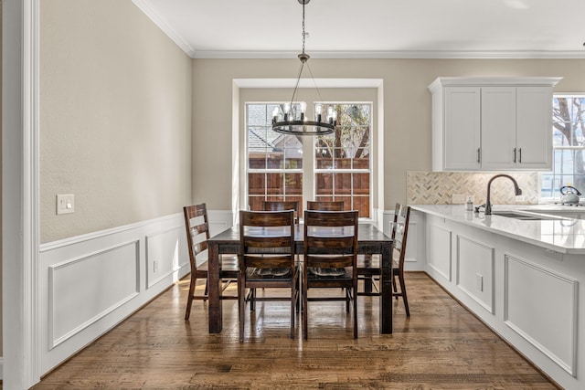 dining room with dark wood-type flooring, a wealth of natural light, and a notable chandelier