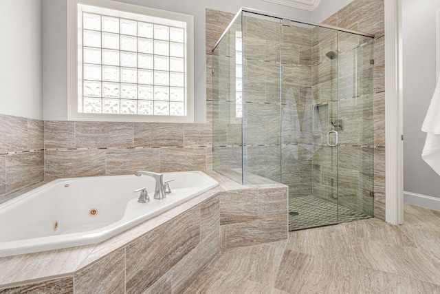 bathroom featuring a shower stall and a tub with jets