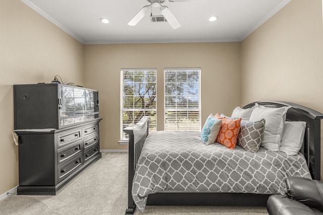 bedroom with baseboards, visible vents, light colored carpet, ceiling fan, and ornamental molding