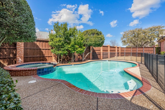 view of swimming pool featuring a pool with connected hot tub and a fenced backyard