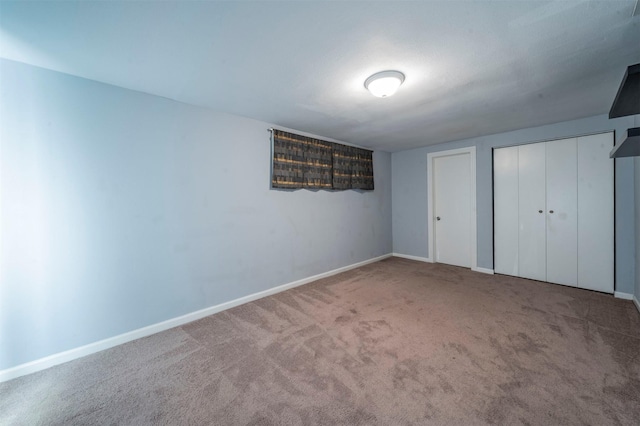 unfurnished bedroom featuring carpet floors and baseboards