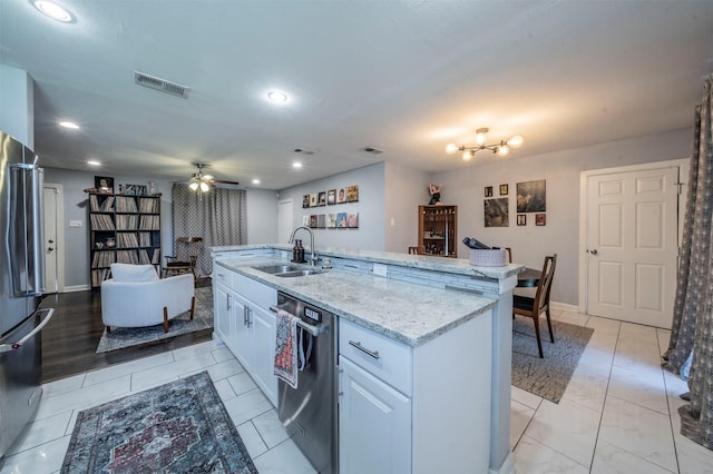 1216 Fuller Dr, Dallas, TX 75218 - kitchen with a ceiling fan, appliances with stainless steel finishes, visible vents, a sink, and an island with sink