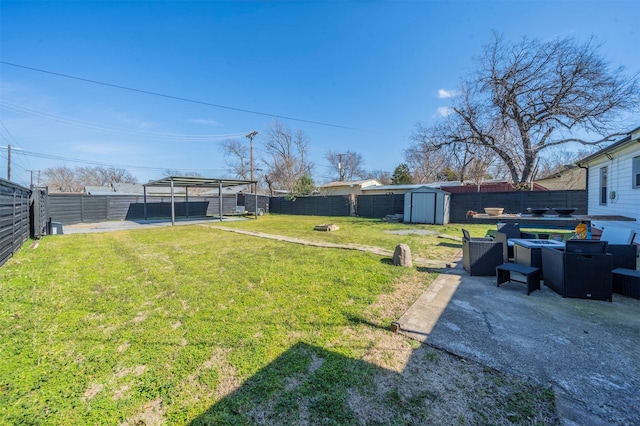 view of yard with a patio area, a fenced backyard, an outdoor structure, and a storage shed