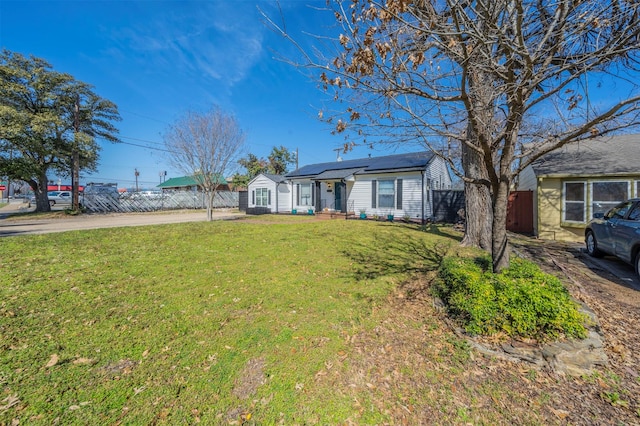 1216 Fuller Dr, Dallas, TX 75218 - view of front of home featuring a front lawn, roof mounted solar panels, and fence